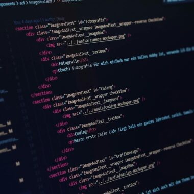 Close-up view of HTML code displayed on a dark screen, showcasing coding concepts.